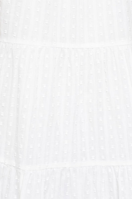 Close-up of 100% cotton fabric used in the sleeveless tiered mini dress, showcasing its lightweight and breathable quality.