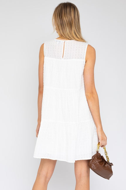 Lightweight sleeveless tiered mini dress, ideal for beach outings and summer vacations.